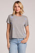 Front view of a woman wearing the Chaser  Allover Stars Tee and jeans on a neutral background