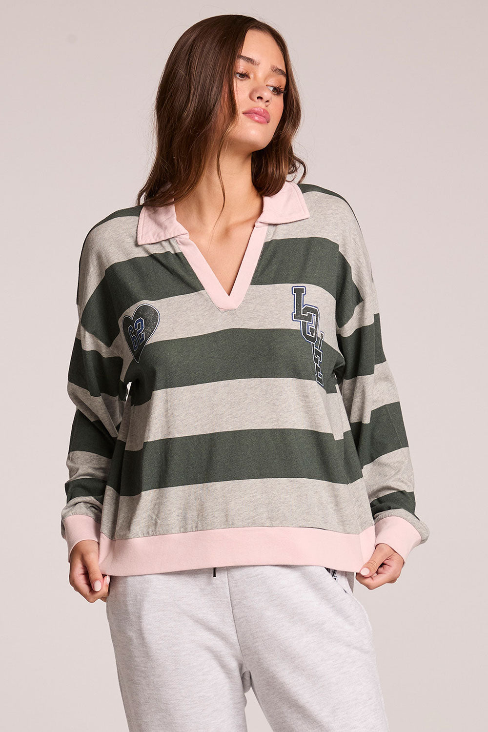 Front view of a woman wearing the Chaser Allstar 62  Long Sleeve and matching pants on a neutral background