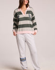 Full body front view of a woman wearing the Chaser Allstar 62  Long Sleeve and clogs on a neutral background