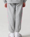 Back view of a girl wearing the Chaser  Bolting Bolt Pant on a neutral background
