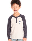 Front view of boy wearing Chaser’s Lightning Bolt henley long sleeve top with three buttons and bold lightning bolt graphic against a white background