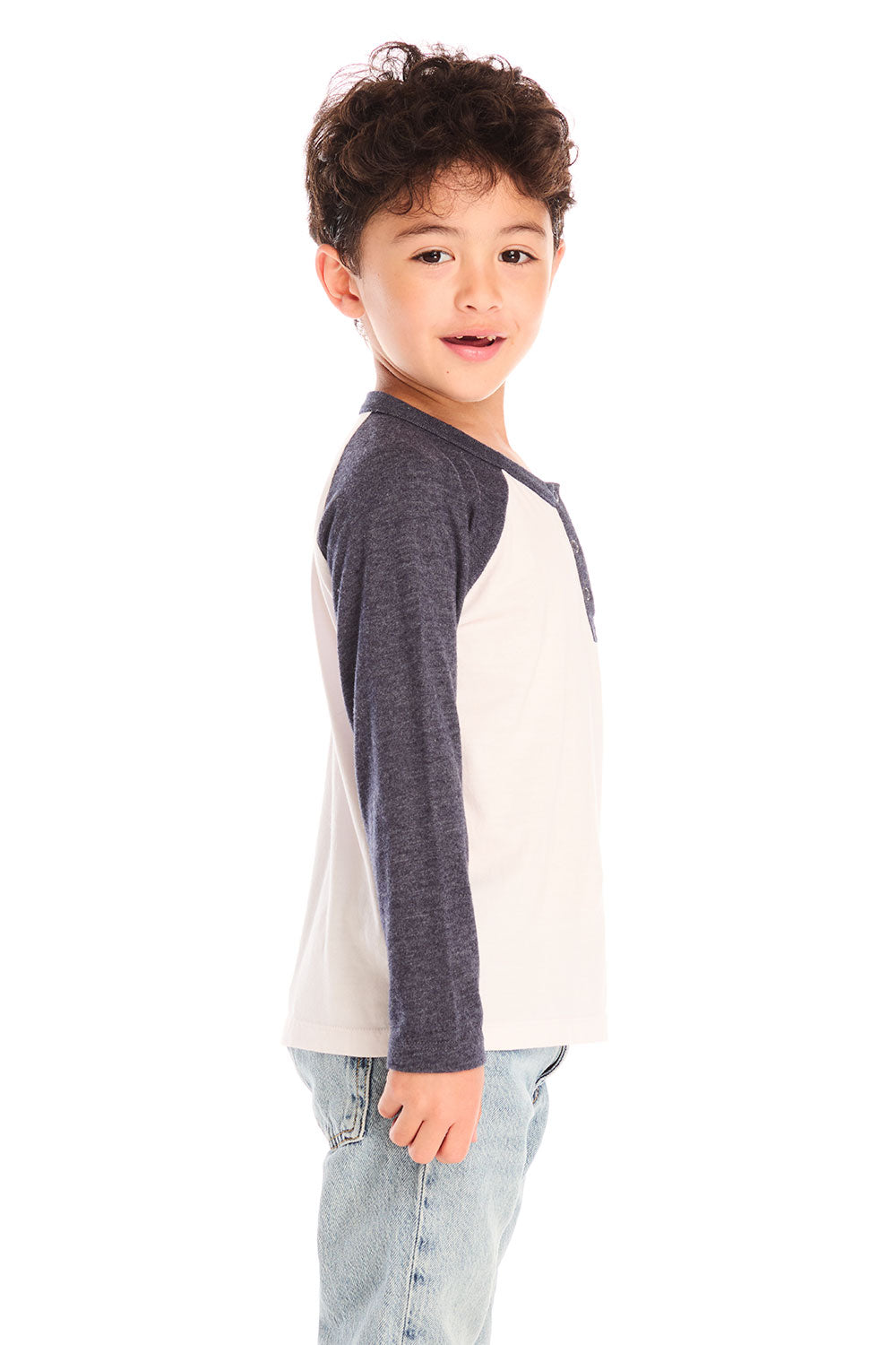 Side view of boy wearing Chaser’s Lightning Bolt henley long sleeve top with jeans on a white background