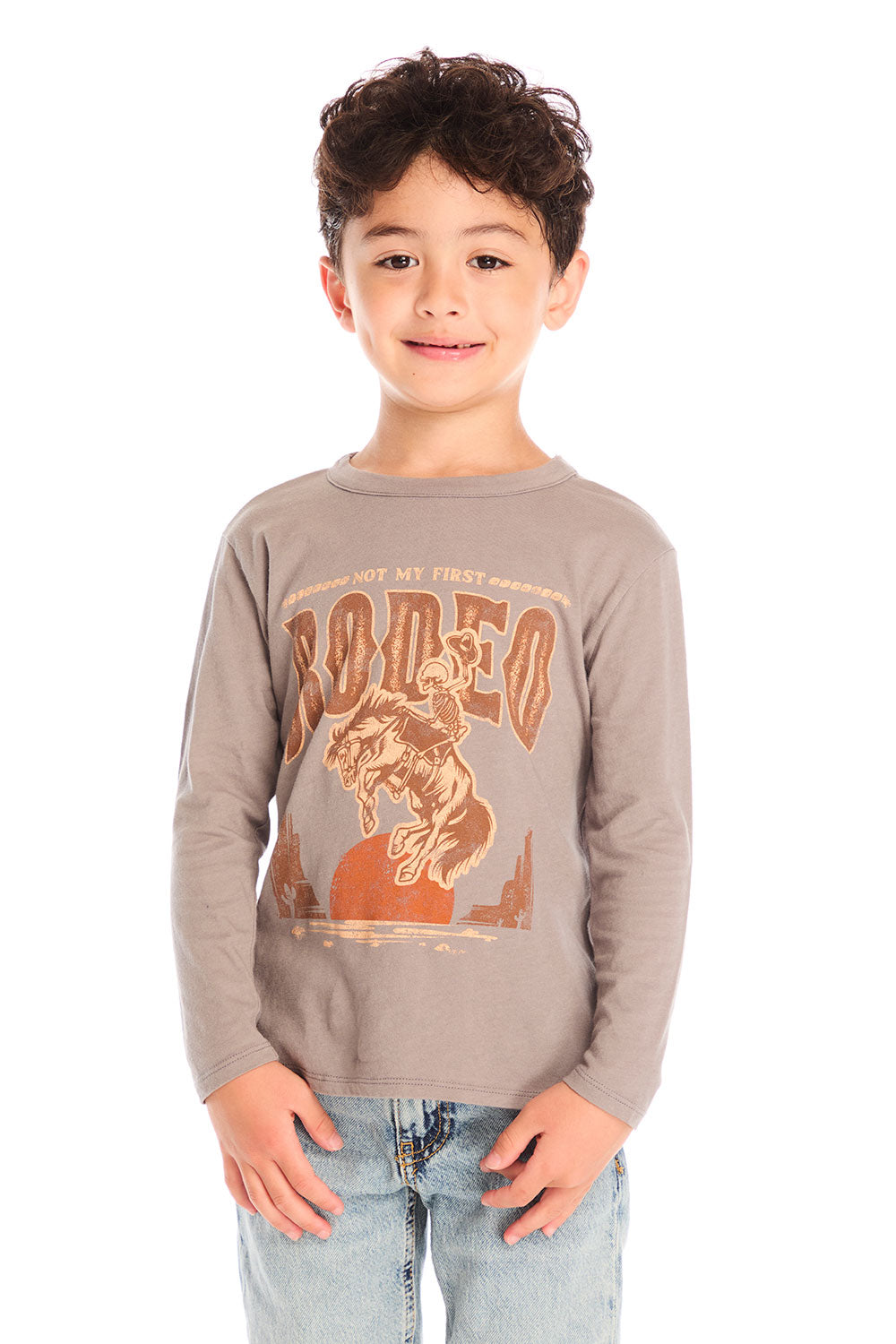 Front view of boy wearing Chaser’s Hold Your Horses dark grey long sleeve with brown rodeo text and cowboy graphic against a white background