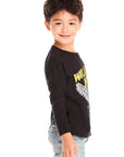 Side view of boy wearing Chaser’s Willie Nelson Willie 1978 black long sleeve with graphic detail on a white background