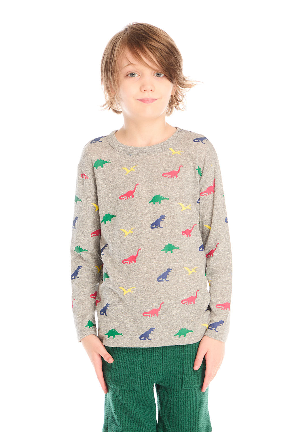 Front view of boy wearing Chaser’s Multi Dinos grey long sleeve top with colorful dinosaur patterns against a white background