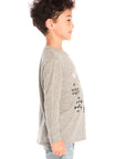 Side view of boy wearing Chaser’s Off To The Races grey long sleeve top with motorcycle and race flag graphic and “Born to Ride” text against a white background