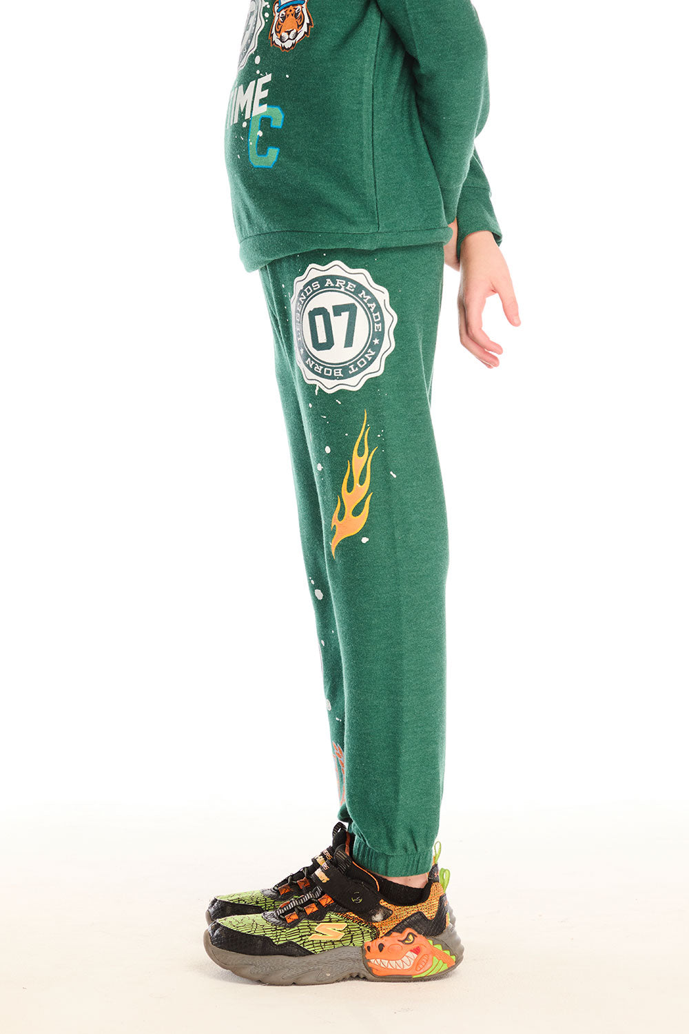 Side view of boy wearing Chaser’s Greatest Of All Time Everest Green pants on a white background