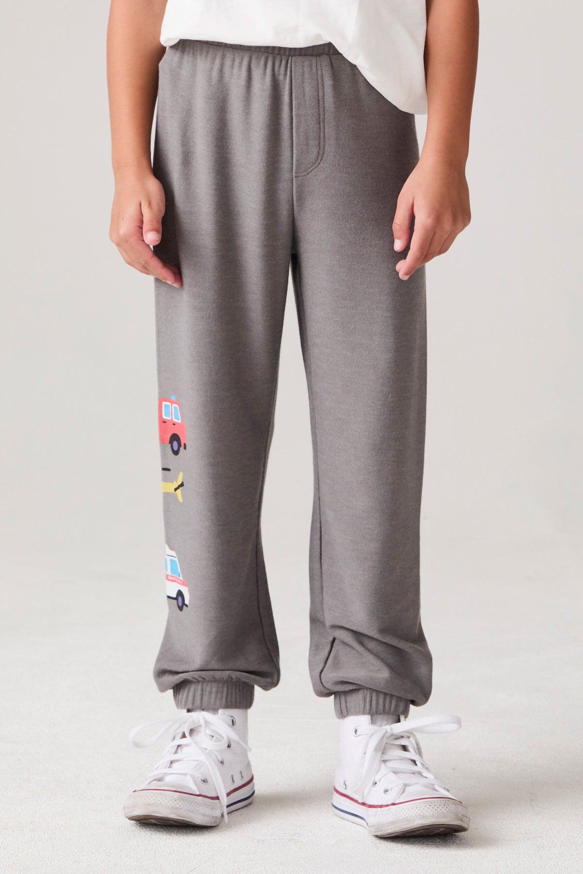 Model wearing Chaser's Heroes Boys Jogger in charcoal with first-responder vehicle graphics, front view