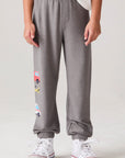 Model wearing Chaser's Heroes Boys Jogger in charcoal with first-responder vehicle graphics, front view