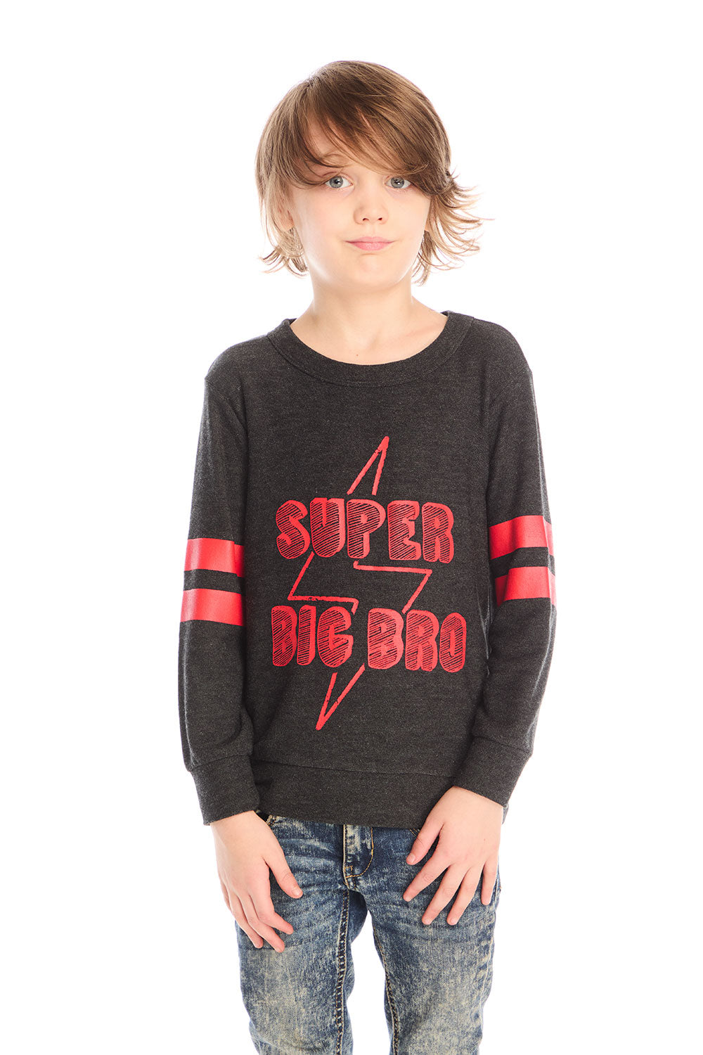 Boy wearing Chaser’s Best Brother Ever black long-sleeve shirt with red text and striped sleeves, paired with blue jeans on a white background