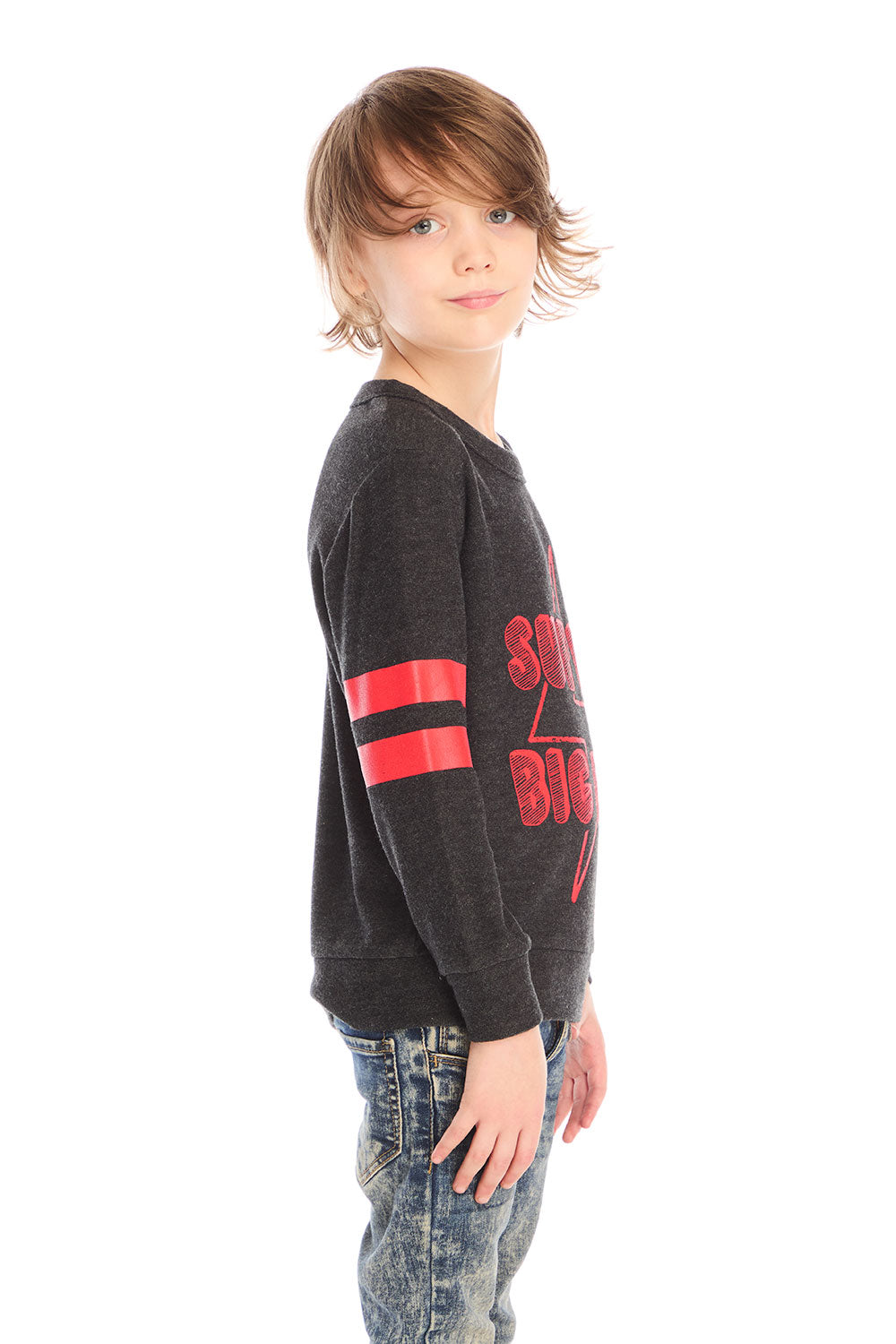 Side view of boy wearing Chaser’s Best Brother Ever black long-sleeve shirt with red text and striped sleeves, paired with blue jeans on a white background