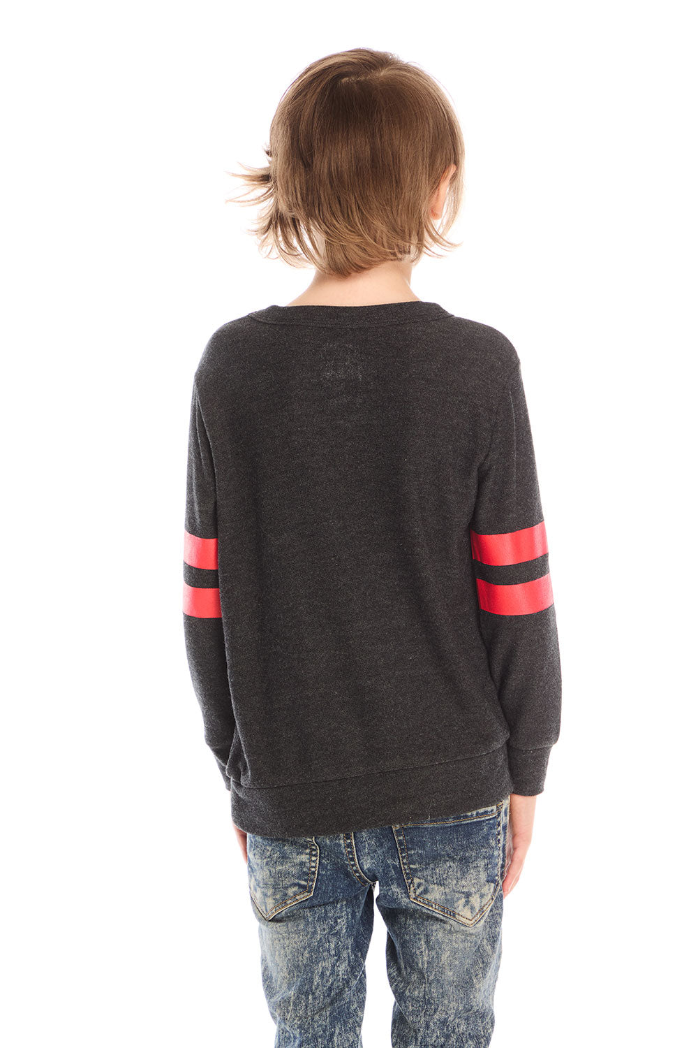 Back view of boy wearing Chaser’s Best Brother Ever black long-sleeve shirt with striped sleeves, paired with blue jeans on a white background