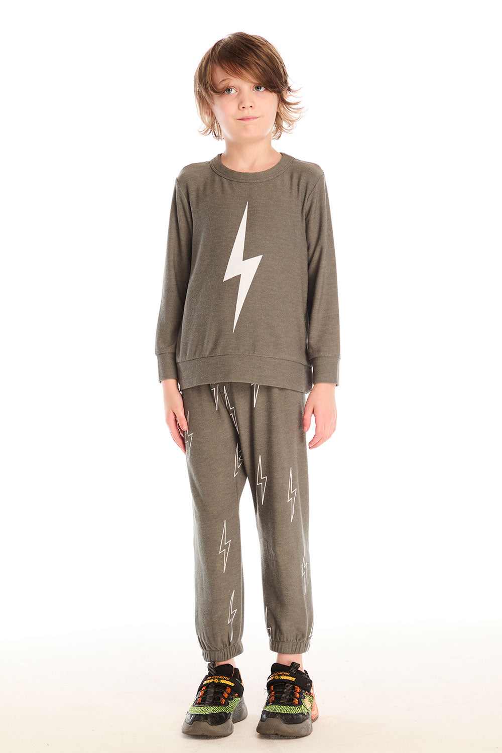 Full body view of boy wearing Chaser’s Bolt safari green long sleeve top with lightning bolt design and matching pants on a white background.
