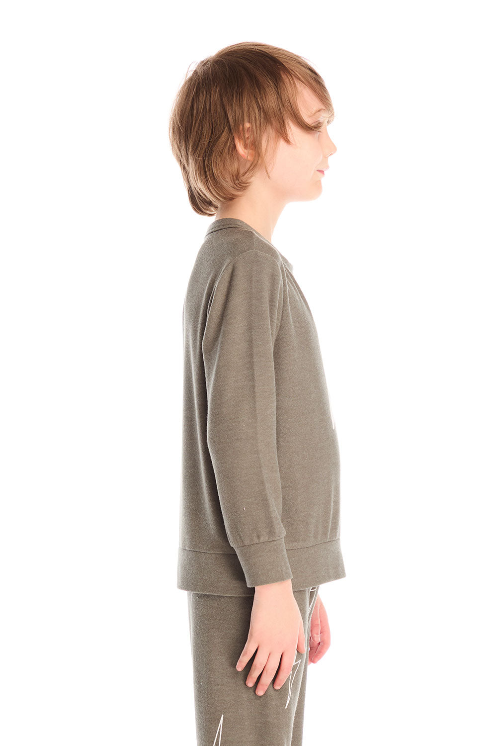 Side view of boy wearing Chaser’s Bolt safari green long sleeve top with lightning bolt design and matching pants on a white background.