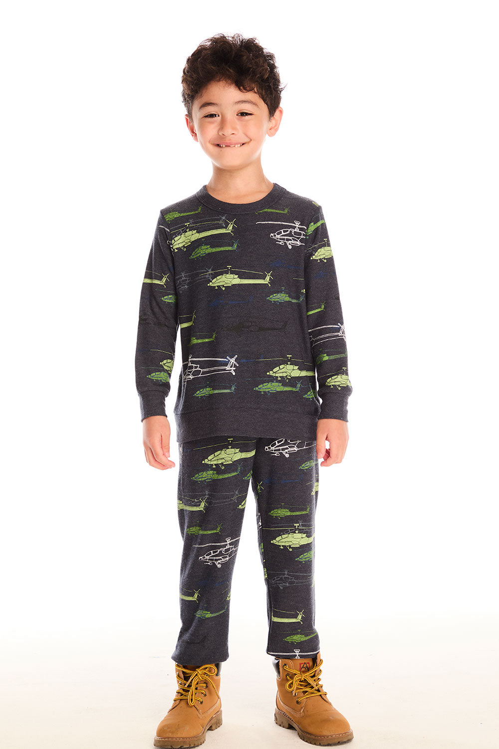 Boy wearing Chaser's dark gray Allover Helicopters pant with green airplane patterns and matching top on a white background