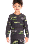 Boy wearing Chaser's dark gray Allover Helicopters long-sleeve shirt and matching pants with helicopter patterns on a white background