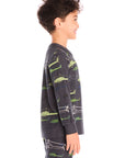 Side view of boy wearing Chaser's dark gray Allover Helicopters long-sleeve shirt and matching pants with helicopter patterns on a white background