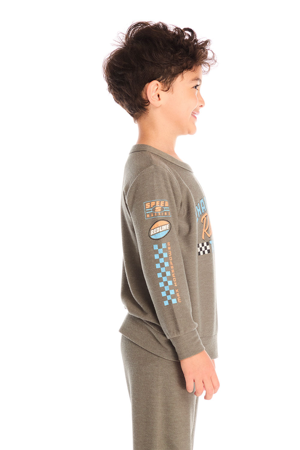 Side view of boy wearing Chaser’s Safari Green Champions Racing Team long sleeve top with matching pants on a white background