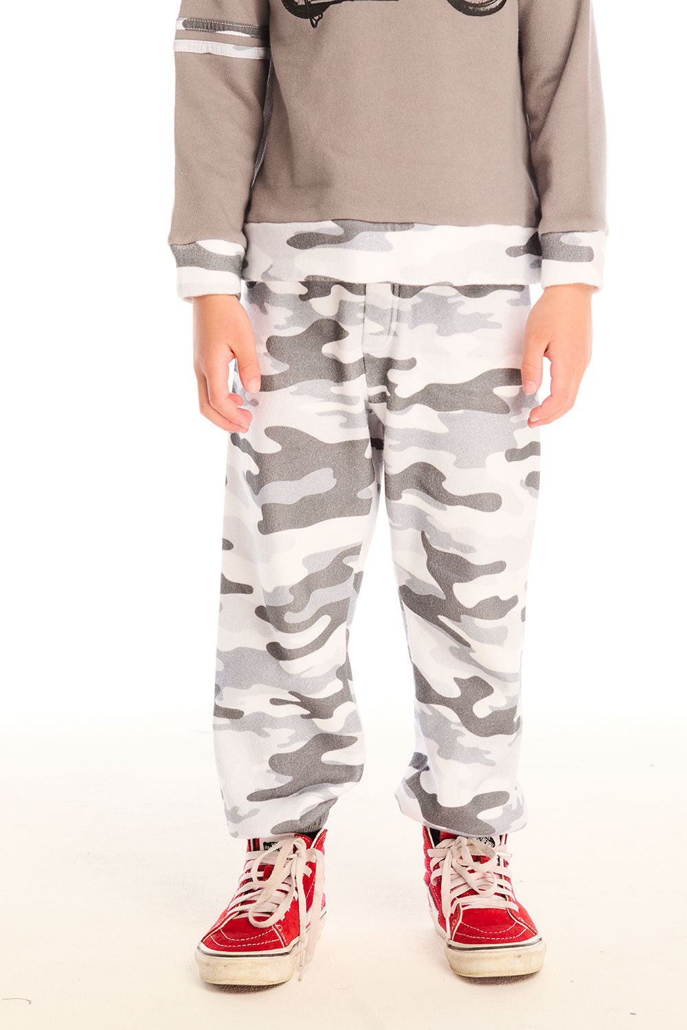 Boy wearing Chaser’s Camo Pants in gray camouflage on a white background.