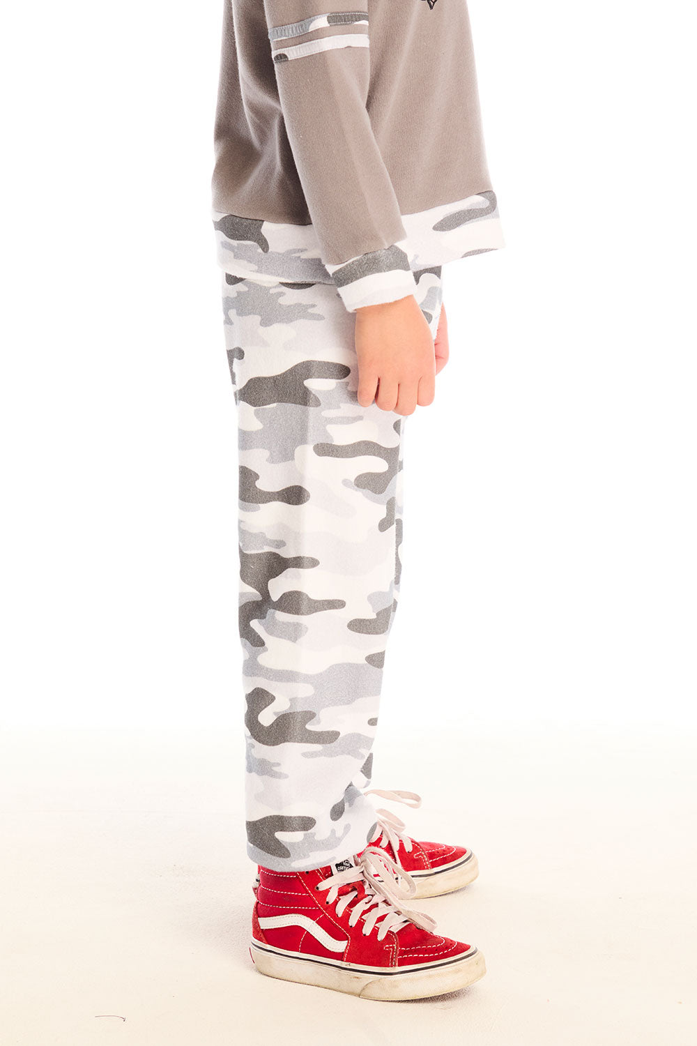 Side view of boy wearing Chaser’s Camo Pants in gray camouflage on a white background.