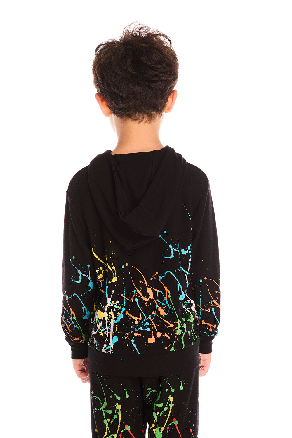 Back view of boy wearing Chaser’s Paint Splatter black hoodie with colorful splatter design and hood up on a white background