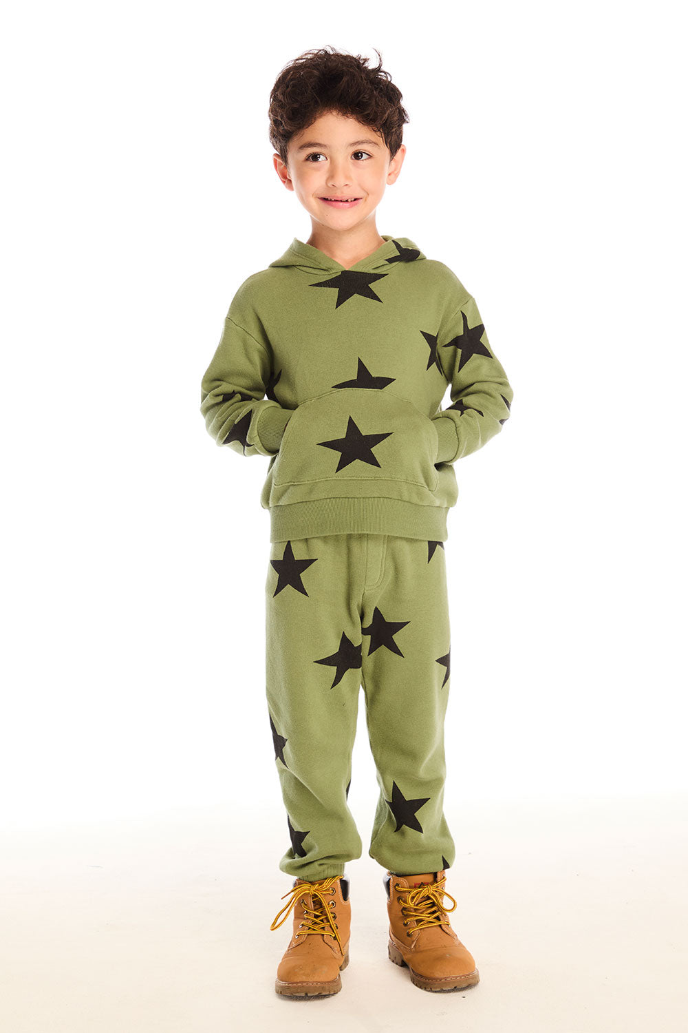 Full view of boy wearing Chaser's Allover Stars green pant and matching hoodie with black star patterns on a white background