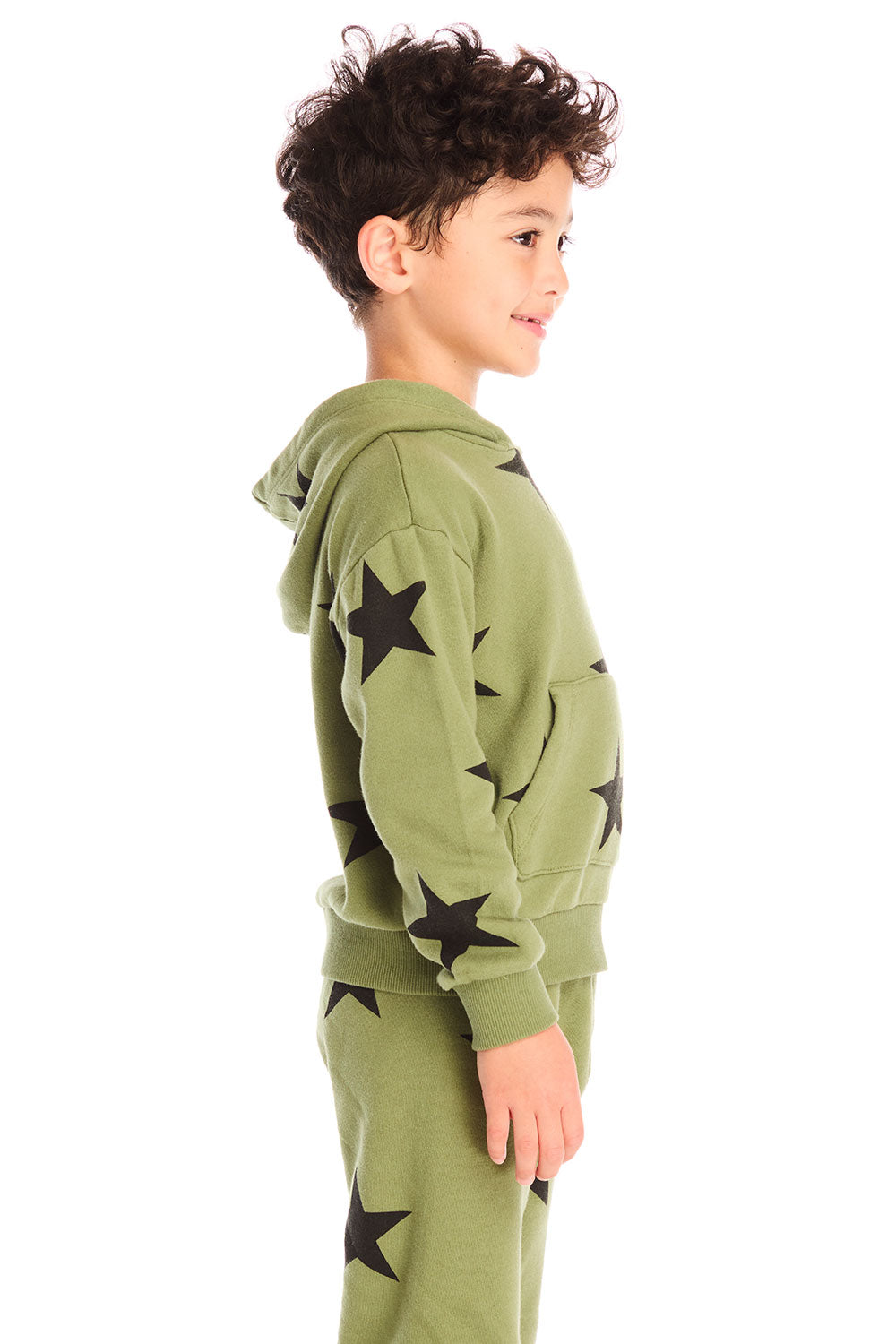Side view of boy wearing Chaser's Allover Stars  green hoodie and matching pants with black star patterns on a white background