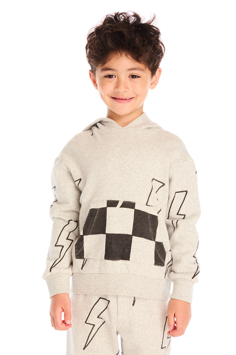 Boy wearing Chaser’s Blocked Checkered Bolts light gray hoodie with black and white checkered pattern and lightning bolt designs on a white background