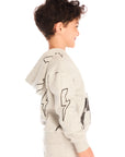 Side view of boy wearing Chaser’s Blocked Checkered Bolts light gray hoodie with checkered pattern and lightning bolt designs on a white background