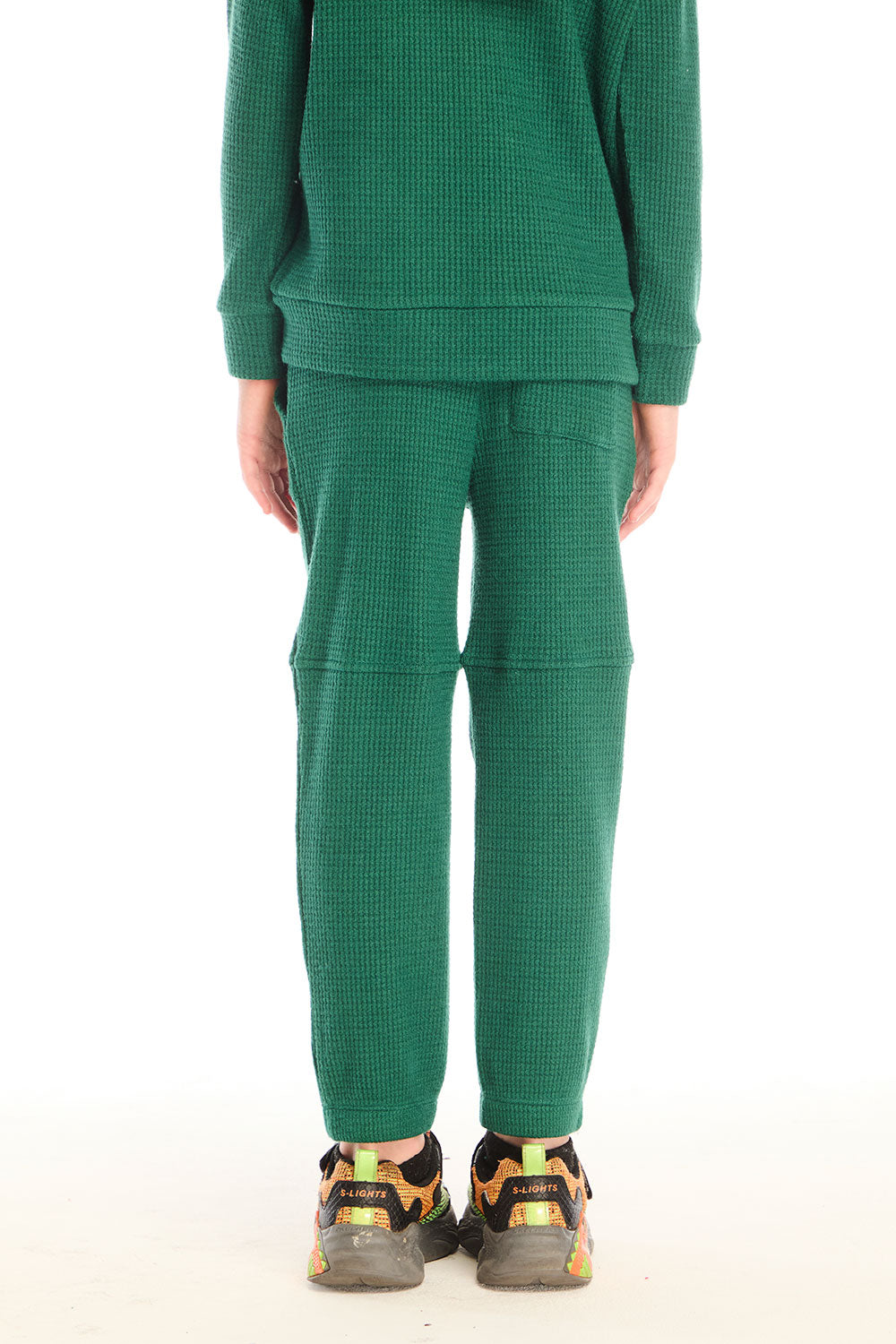 Back view of boy wearing Chaser’s Everest Green Knee Seam Jogger with seam detail on a white background