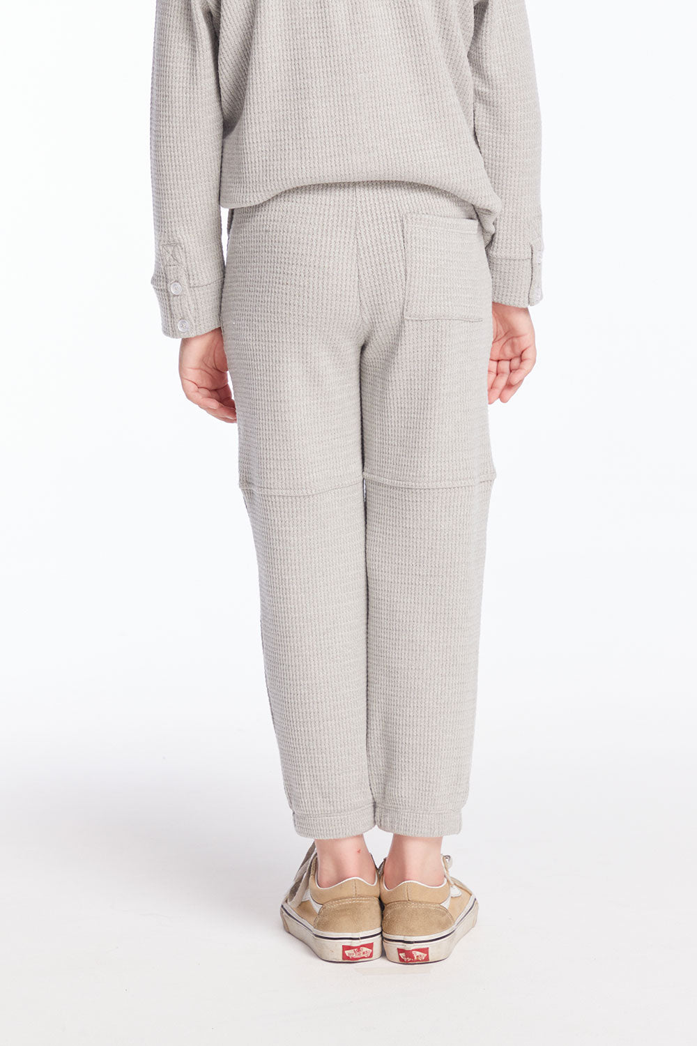  Back view of boy wearing Chaser’s heather grey Knee Seam Joggers with waffle texture against a white background