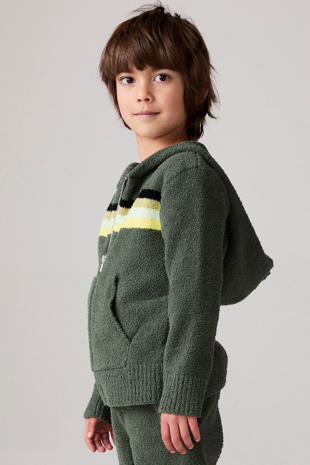 Model wearing Chaser's Lime Stripe Boys Zip-Up Hoodie in leafy green with striped detailing, side view