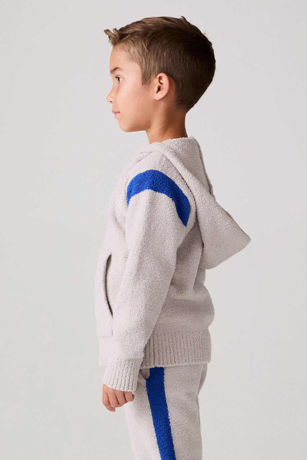Model wearing Chaser's Sporty Colorblock Boys Zip-Up Hoodie in heather grey with colorblock detailing, side view