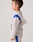 Model wearing Chaser's Sporty Colorblock Boys Zip-Up Hoodie in heather grey with colorblock detailing, side view