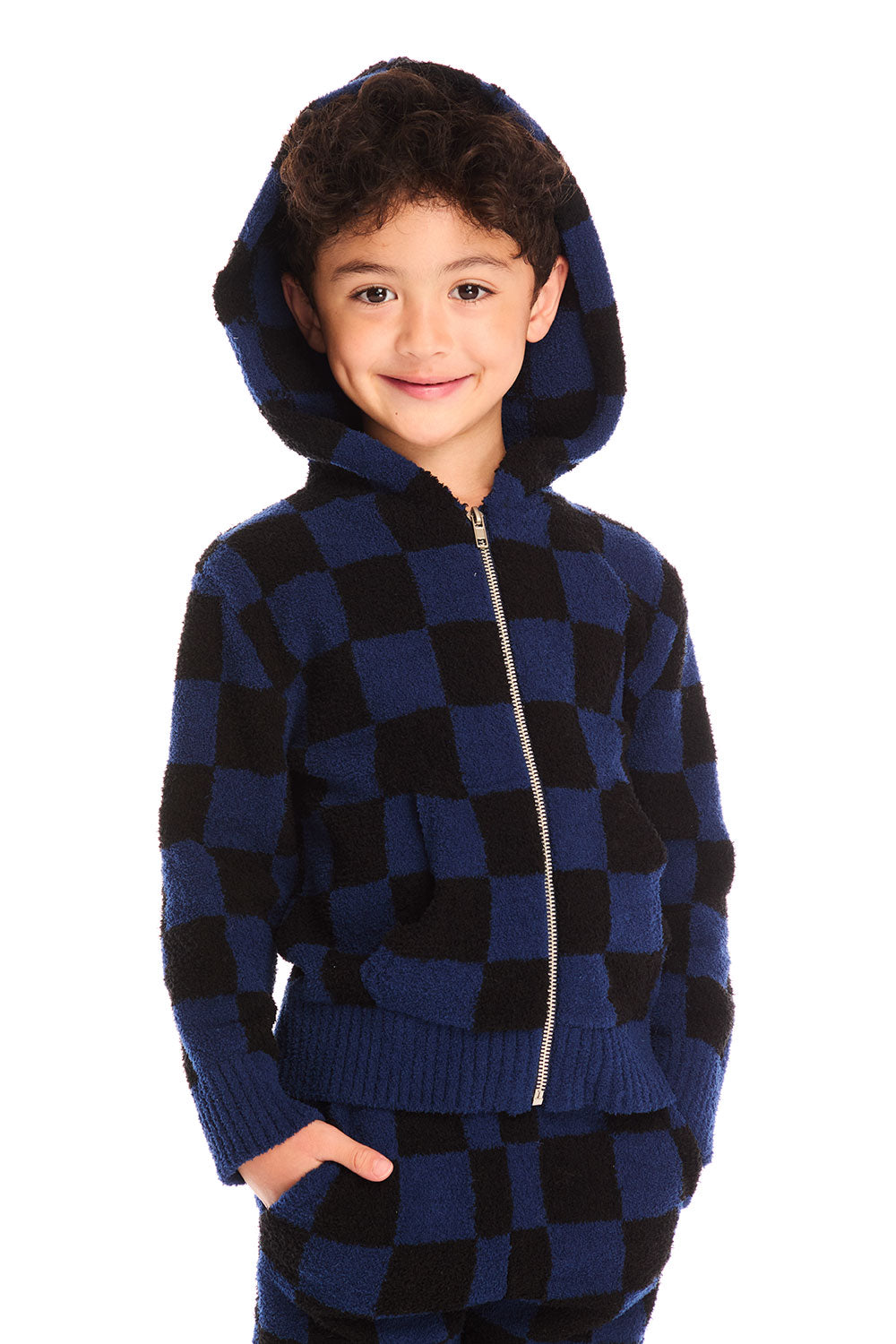 Front view of boy wearing Chaser’s Paxton blue and black checkered zip up hoodie with hood up and matching pants on a white background