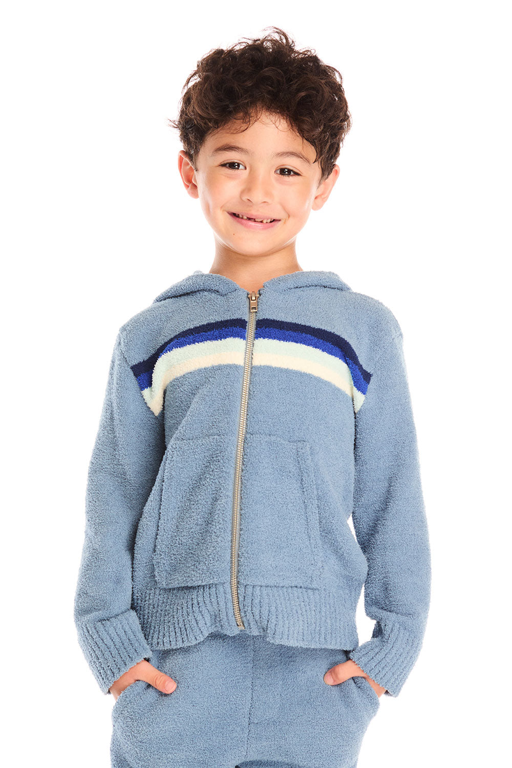 Boy wearing Chaser’s Paxton Zip Up true blue hoodie and a colorful stripe on a white background