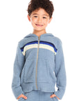 Boy wearing Chaser’s Paxton Zip Up true blue hoodie and a colorful stripe on a white background