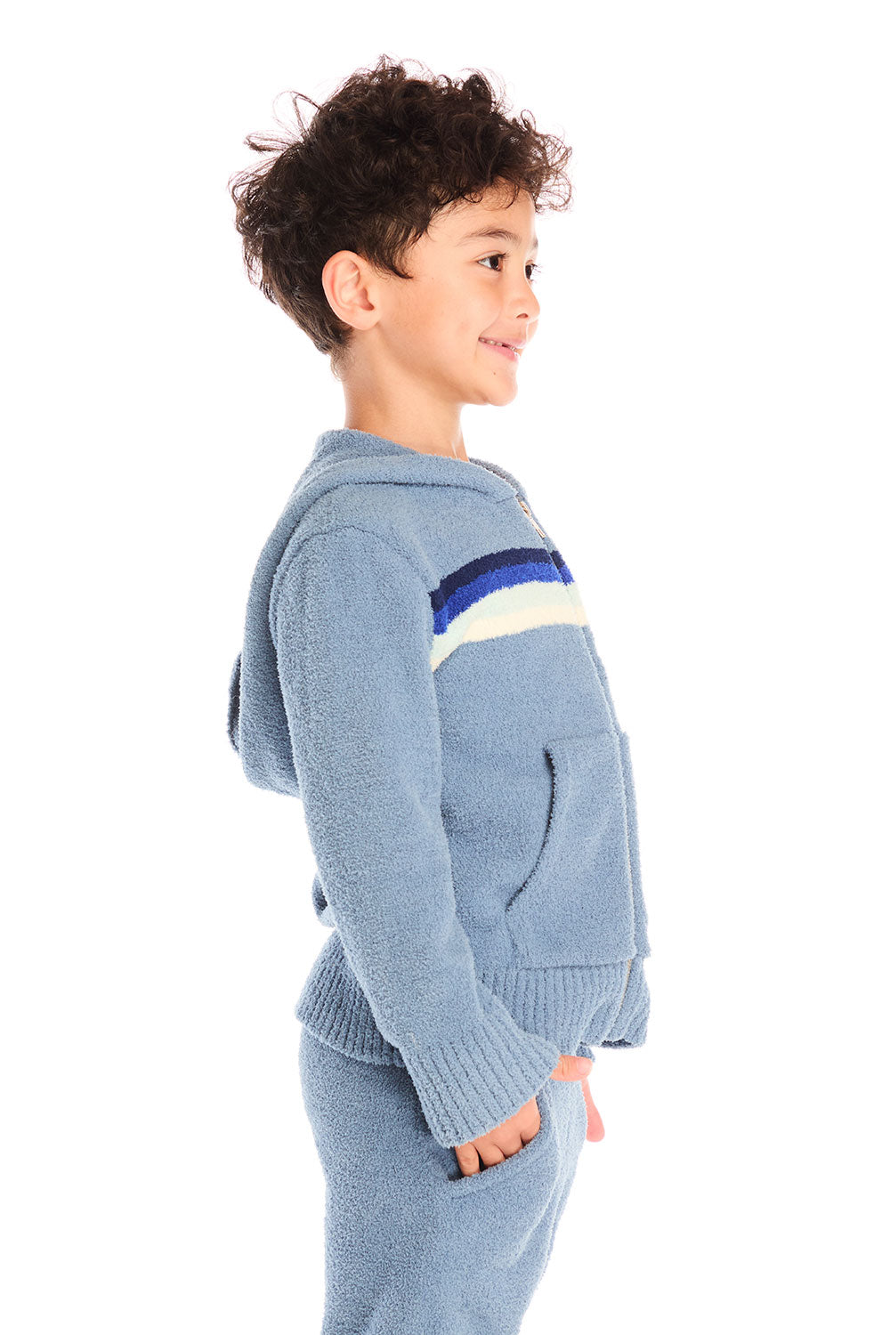 Side view of boy wearing Chaser’s Paxton Zip Up true blue hoodie and a colorful stripe on a white background