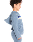Side view of boy wearing Chaser’s Paxton Zip Up true blue hoodie and a colorful stripe on a white background