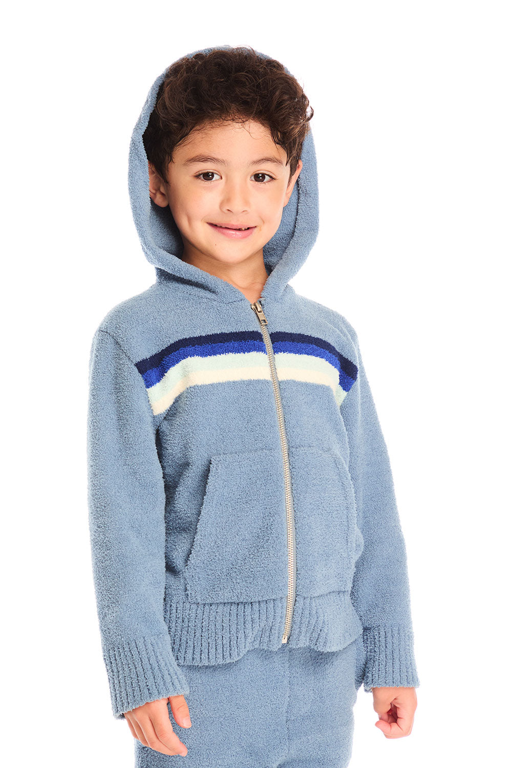 Boy wearing Chaser’s Paxton Zip Up true blue hoodie with hood up and a colorful stripe on a white background