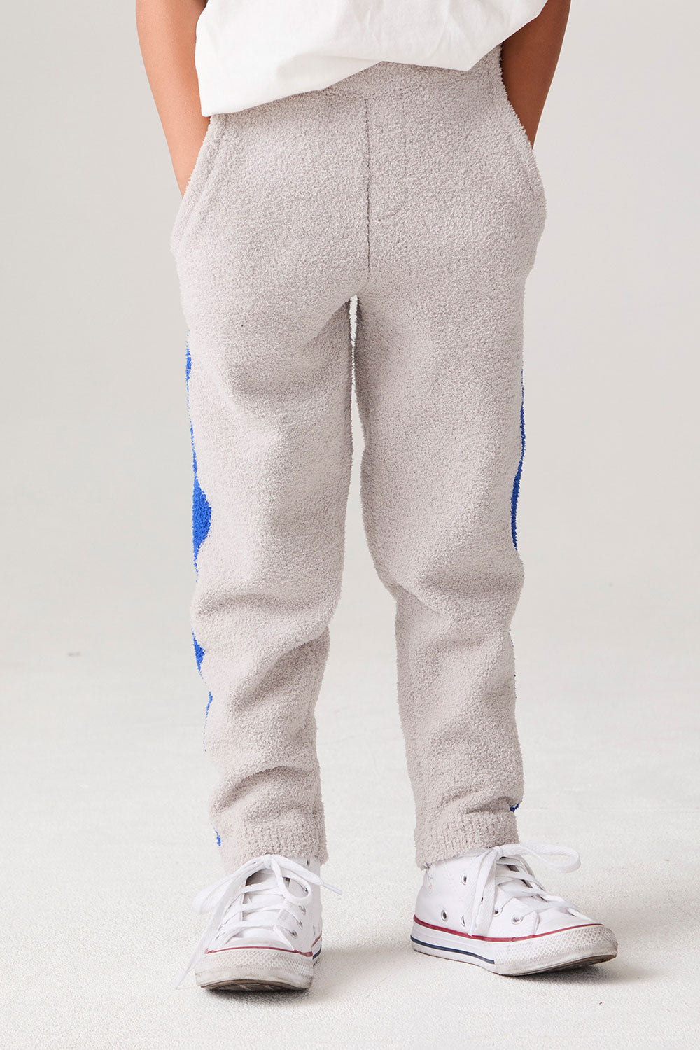 Model wearing Chaser's Sporty Colorblock Boys Lounge Pants in heather grey with colorblock detailing, front view