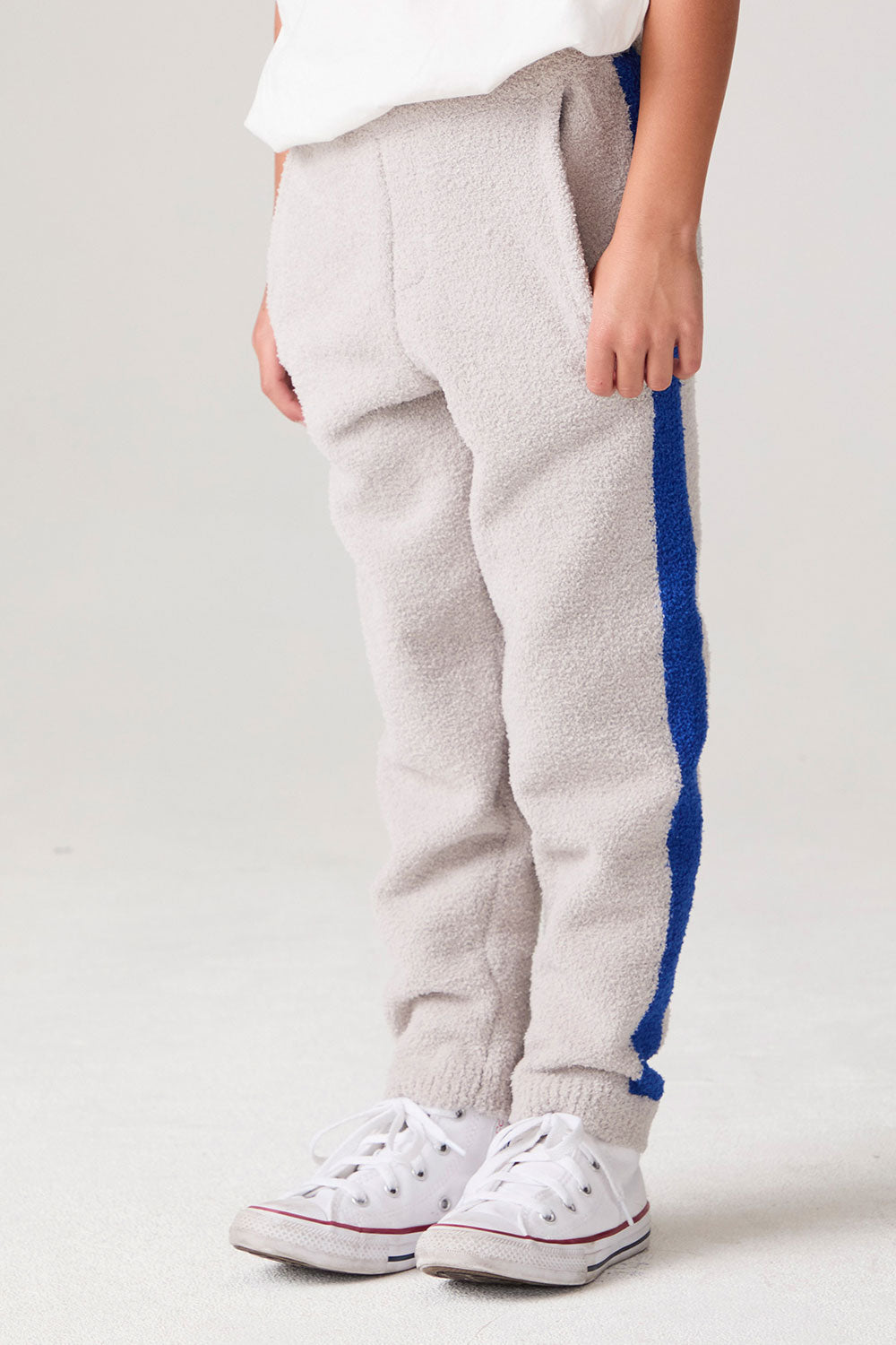 Model wearing Chaser's Sporty Colorblock Boys Lounge Pants in heather grey with colorblock detailing, side view