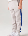 Model wearing Chaser's Sporty Colorblock Boys Lounge Pants in heather grey with colorblock detailing, side view