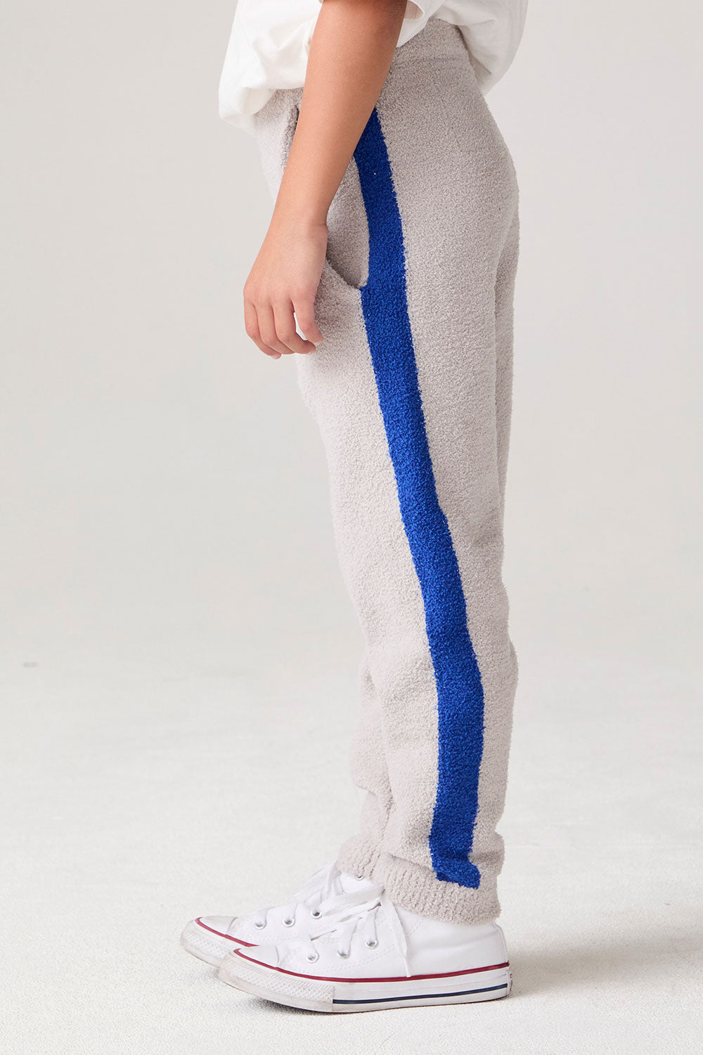 Model wearing Chaser's Sporty Colorblock Boys Lounge Pants in heather grey with colorblock detailing, back view