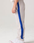 Model wearing Chaser's Sporty Colorblock Boys Lounge Pants in heather grey with colorblock detailing, back view