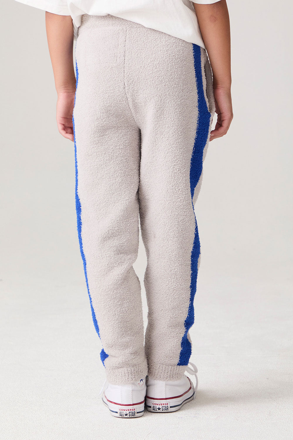 Model wearing Chaser's Sporty Colorblock Boys Lounge Pants in heather grey with colorblock detailing, detail view