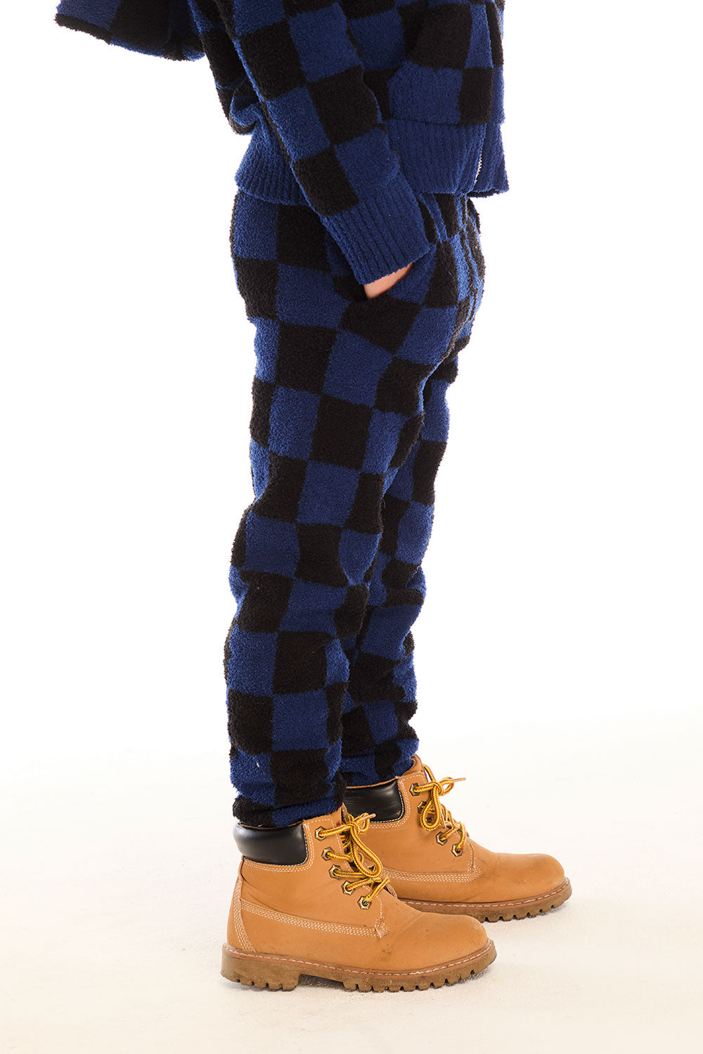 Side view of boy wearing Chaser’s blue checkered Lounge Pant with Pocket against a white background