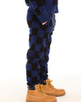 Side view of boy wearing Chaser’s blue checkered Lounge Pant with Pocket against a white background