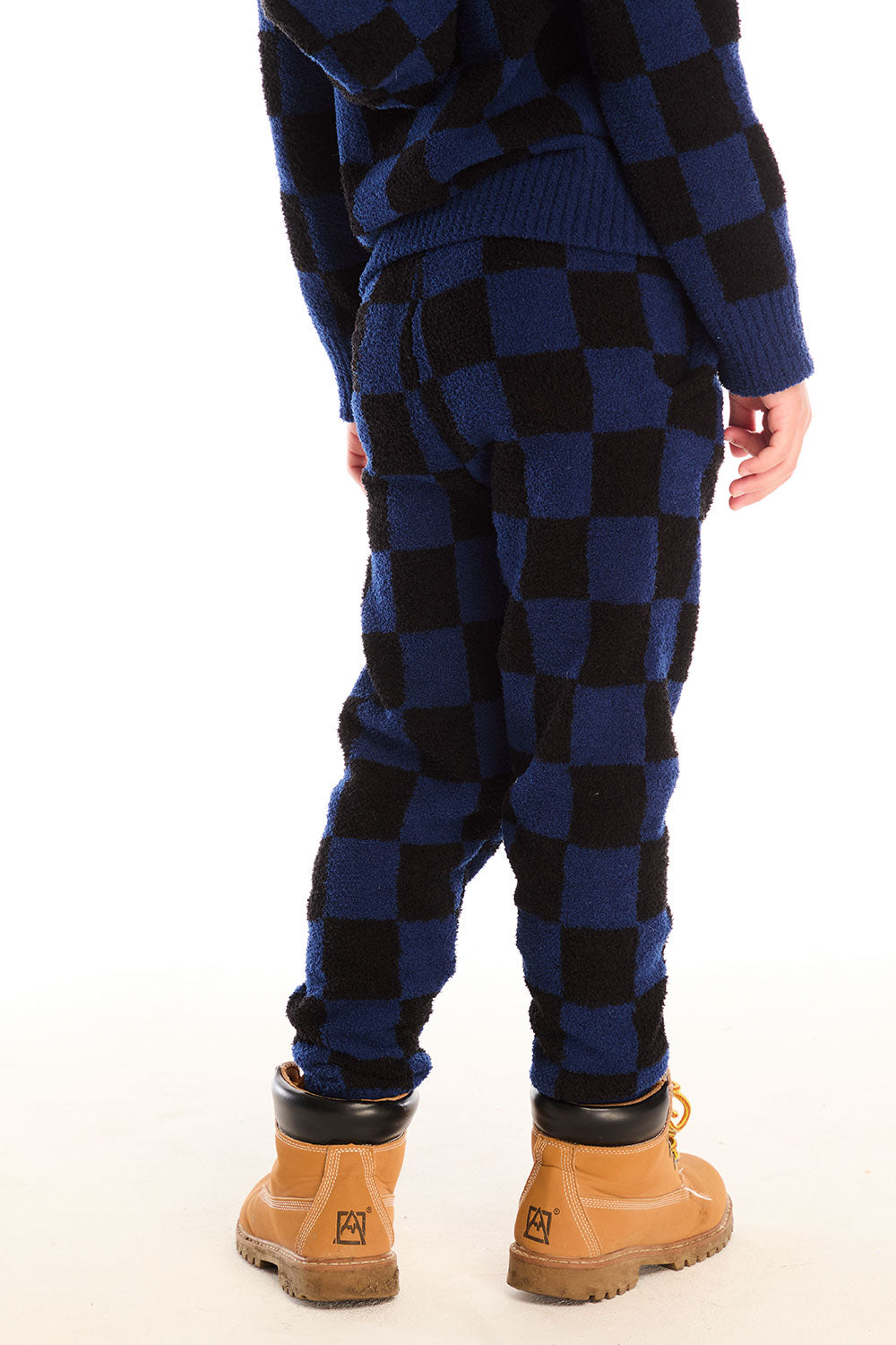 Back view of boy wearing Chaser’s blue checkered Lounge Pant against a white background