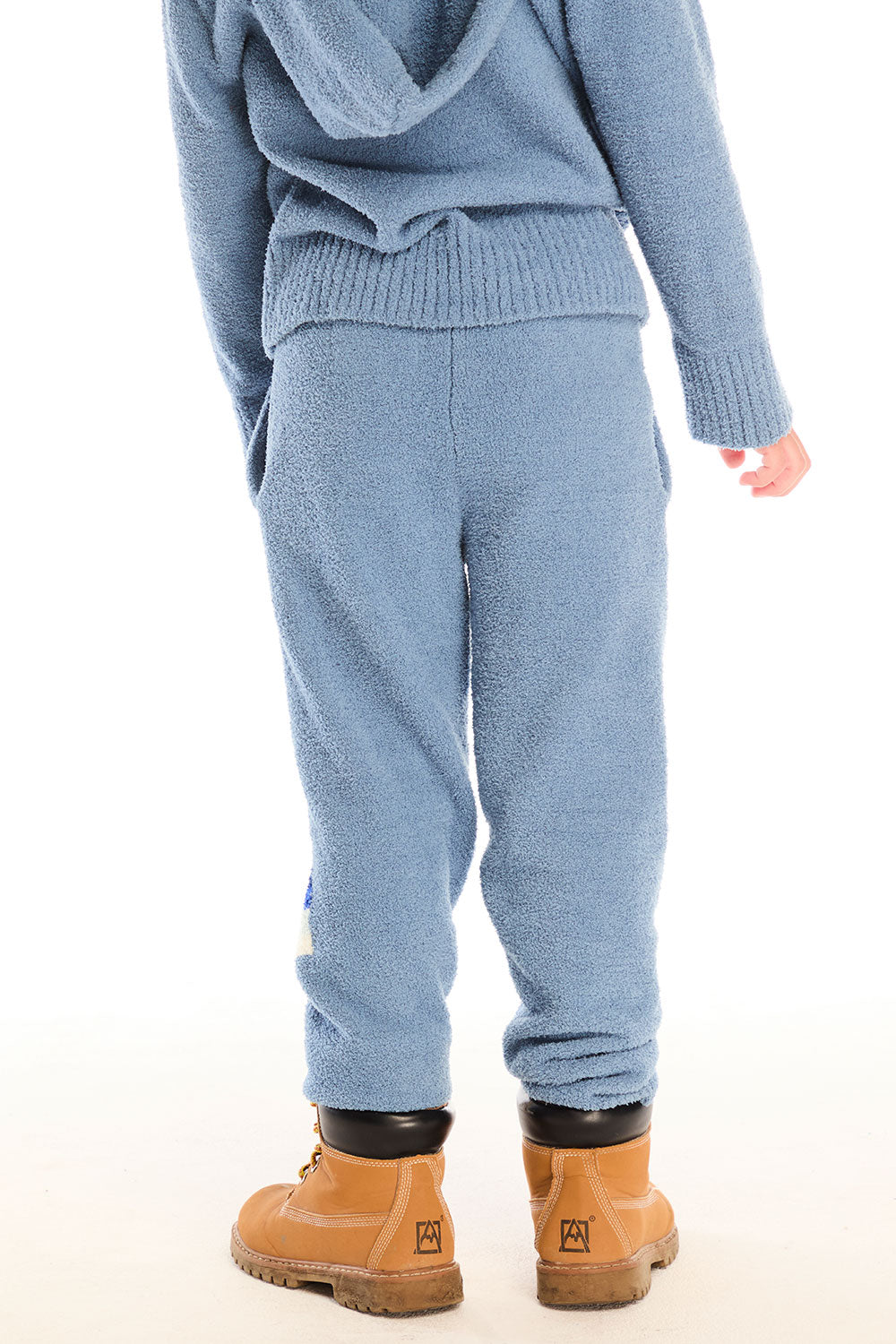 Back view of boy wearing Chaser’s Lounge Tahoe Blue Pant with Pocket with matching zip up hoodie on a white background